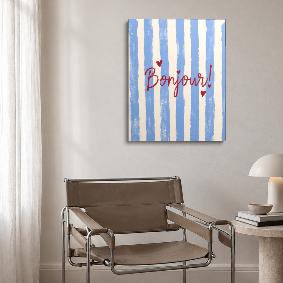 Toile Bien le Bonjour accrochée au-dessus d’un fauteuil en cuir et acier