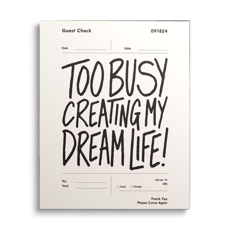 Toile Dream Life vue de face sur fond blanc : ticket de restaurant crème avec l’inscription manuscrite « Too busy creating my dream life! »